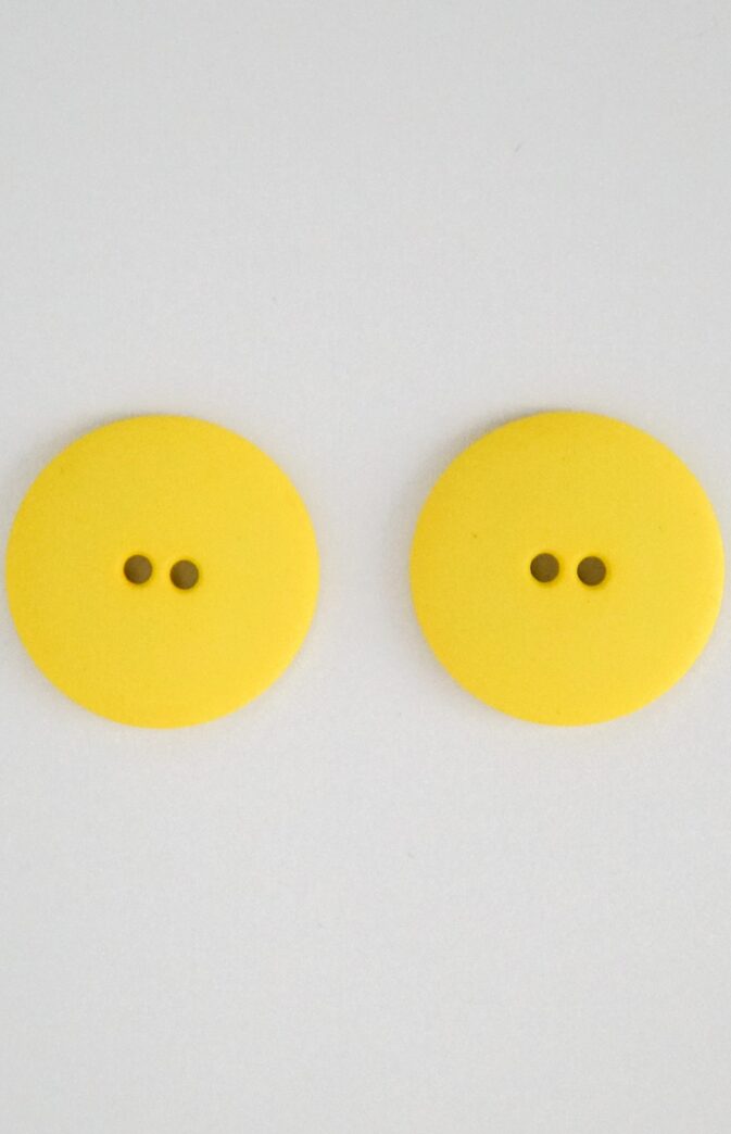 yellow plastic button
